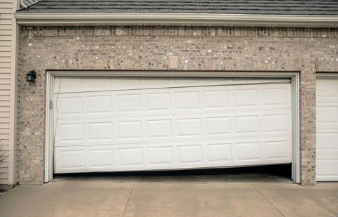 White garage door off track before repair